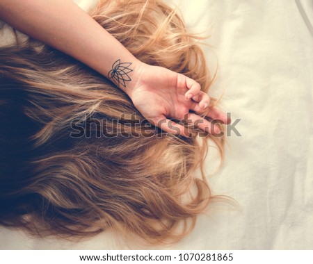 Woman with Brunette Hair Lying Down on the Bed