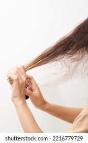 Woman Brush Her Dry And Frizzy Natural Curly Hair That Needs Hydration. Natural Curls Before Salon Treatment. Close Up.