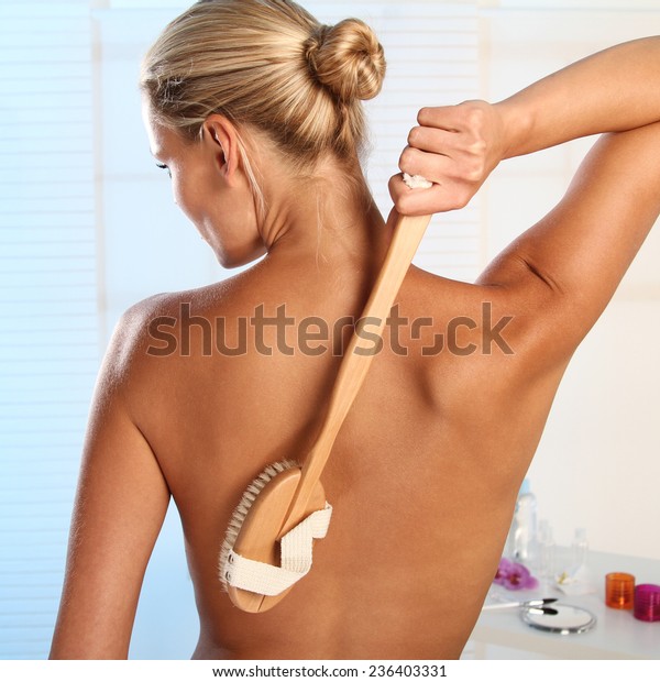 woman brushing her\
back