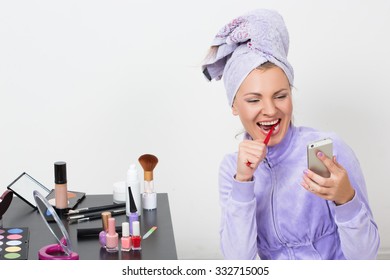 Woman Brushing Her Teeth And Talking On The Phone