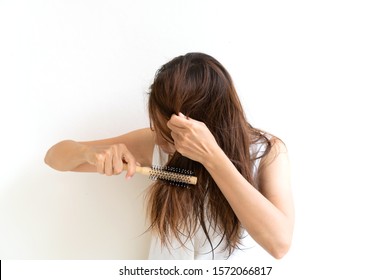 Woman brushing her wet messy hair after bath with comb, Thin hair porblem. Hair Damage, Health And Beauty Concept.