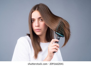 Woman brushing straight natural hair with comb. Girl combing hair with hairbrush. Hair care beauty concept. Brushing Hair.