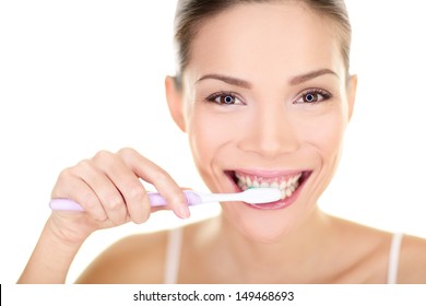 Woman Brushing Teeth Holding Toothbrush. Dental Care Close Up Portrait Of Beautiful Girl Brushing Teeth Smiling Happy Looking At Camera Isolated On White Background. Mixed Race Asian Chinese Caucasian