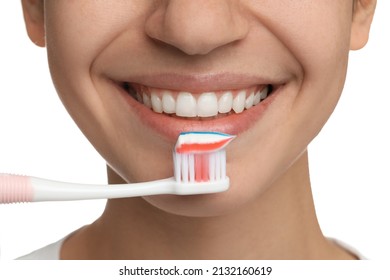 Woman Brushing Teeth With Paste On White Background, Closeup. Dental Care