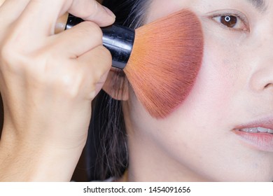 woman  are brushing their cheeks to look smoother.