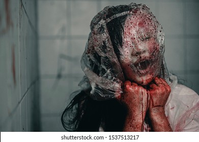 A woman is brutally murdered by a bag over her head. Feeling tortured and needing help, Halloween murder concept.