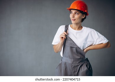 Woman Builder In Helmet Wearing Grey Overalls