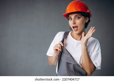 Woman Builder In Helmet Wearing Grey Overalls