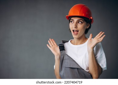 Woman Builder In Helmet Wearing Grey Overalls