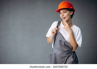 Woman Builder In Helmet Wearing Grey Overalls