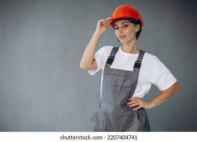 Woman Builder In Helmet Wearing Grey Overalls