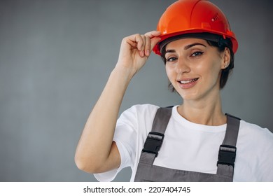 Woman Builder In Helmet Wearing Grey Overalls