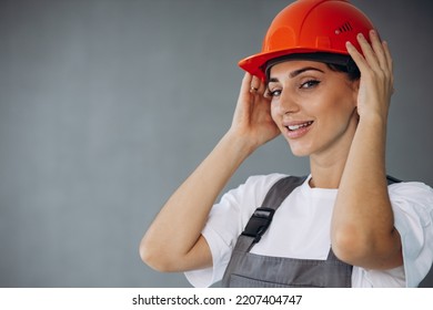 Woman Builder In Helmet Wearing Grey Overalls