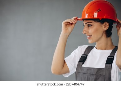 Woman Builder In Helmet Wearing Grey Overalls