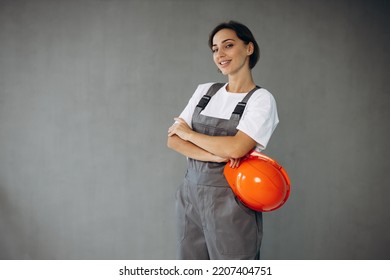 Woman Builder In Helmet Wearing Grey Overalls