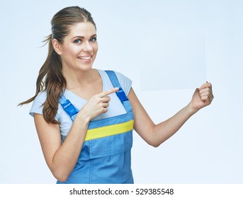 Woman builder holding white blank advertising banner point finger on copy space. Isolated portrait. - Powered by Shutterstock