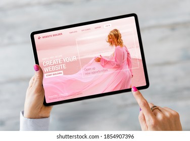 Woman building her website on tablet computer