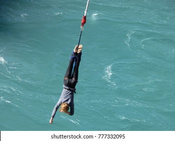 Woman Bungee Jumping Off A Bridge Into The River