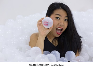 Woman Buried In White Plastic Balls