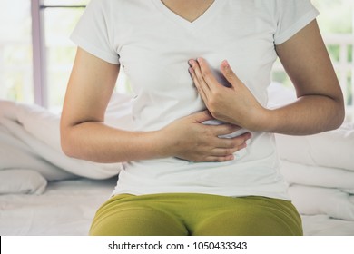 Woman Burning In The Chest Suffering From Acid Reflux Or Heartburn, Diarrhea, Indigestive Problem
