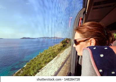 The Woman In The Bus Looks Out Of The Window On A Sea Landscape