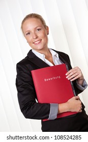 A Woman In Business Attire With A Job Application. Proper Clothing For The Interview.