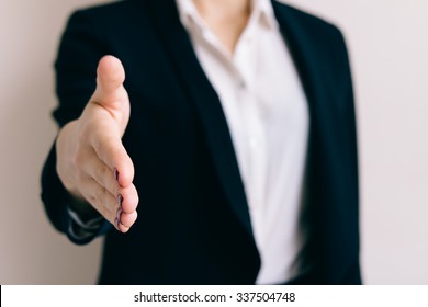 Woman In A Business Suit Holds Out Her Hand For A Handshake Closeup.