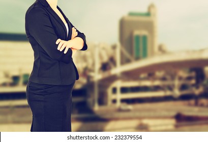 woman in business suit on a city building background. filtered image