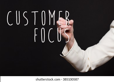 Woman In Business Suit Writing - Customer Focus