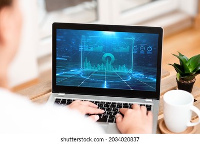 Woman Busy Typing On Her Laptop Beside Coffe Mug And Plant Accomplishing Work From Home. Girl Encoding Minicomputer Next To Cap And Flower Finishing Remote Jobs. - Shutterstock ID 2034020837