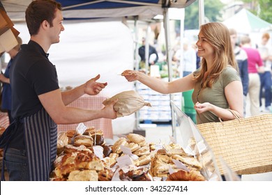 Woman Buying Bread From Market Stall