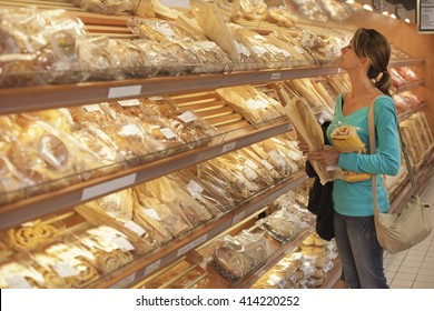 Woman Buying Bread At The Supermarket