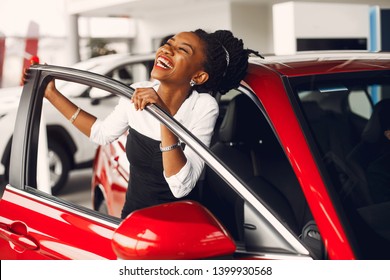 Woman buying the car. Lady in a car salon. Elegant black girl - Shutterstock ID 1399930568