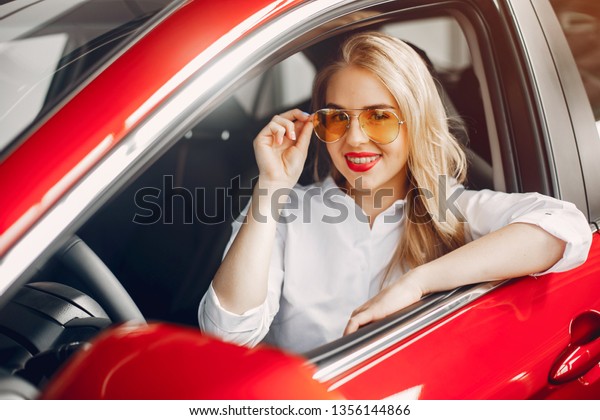 Woman buying the car.
Lady in a car salon