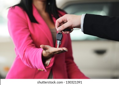 Woman Buying A Car And Salesman Handling Keys