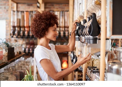 Woman Buying Cereals And Grains In Sustainable Plastic Free Grocery Store