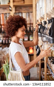 Woman Buying Cereals And Grains In Sustainable Plastic Free Grocery Store