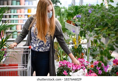 Woman Buying Flowers Shopping Cart Garden Center With Face Mask. USA. High Quality Photo