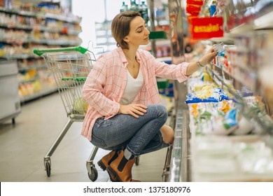 Woman buying at grocery store - Shutterstock ID 1375180976