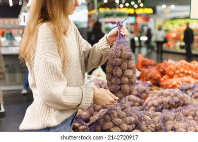 Woman buying potatoes in food store. - Powered by Shutterstock