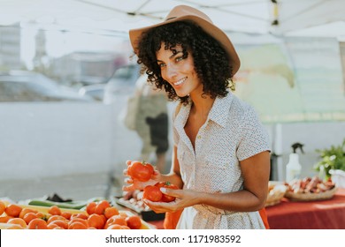 Woman Buying Tomatoes At A Farmers Market