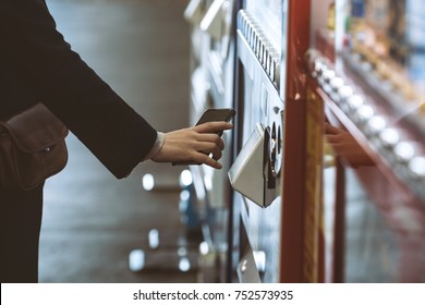 Woman buying with a vending machine - Shutterstock ID 752573935