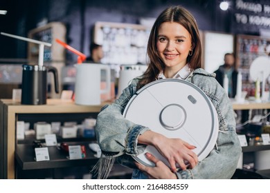 Woman Buying Wireless Vacuum Cleaner At Store