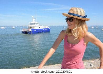 Woman By Harbour Wall Ferry In Background