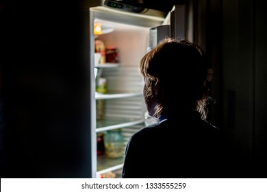 Woman By The Open Refrigerator At Night