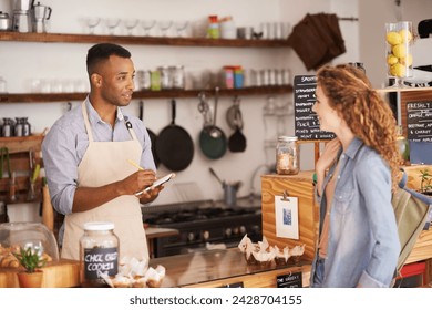 Woman, cafe and barista with order at counter for purchase, shopping and lunch at coffee shop. Female person, small business and waiter with notepad for discussion, writing and customer service - Powered by Shutterstock