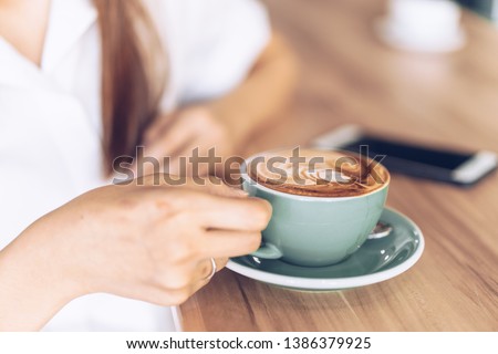 woman in a cafe drinking coffee .Portrait of Asian woman smiling in coffee shop cafe vintage color tone