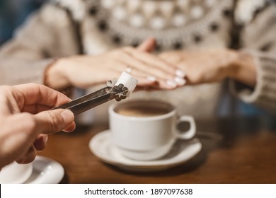 A Woman In A Cafe Refuses A Piece Of White Sugar For Her Tea. Say No To Sugar And Fast Carbs. Diet For Diabetes And Addiction To Sweet Junk Food