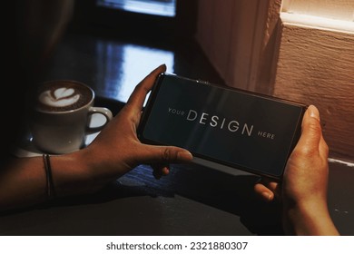 Woman in a cafe using a mobile phone mockup
