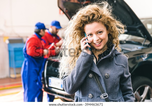 Woman\
calling car assistance service after car break\
down